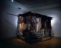 Birth of A Nation (Shack from Bob Marley’s town in Jamaica), 1988 / 
wood shack, tv's / 
116 x 108 x 96 in (294.6 x 274.3 x 243.8 cm) / 