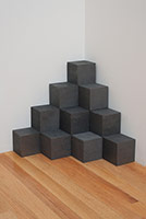 Carl Andre / 
Carbon Quarry, 2004 / 
carbon, 20 units / 
each: 3 15/16 x 3 15/16 x 3 15/16 in. (10 x 10 x 10 cm) / 
overall: 15 3/4 x 15 3/4 x 15 3/4 in. (40 x 40 x 40 cm)