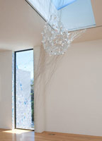 Fran Siegel / 
Fugitive, 2009 / 
porcelain; wire; paper mache; monofilament; reflective mylar; tinted films / 
approx. 90 x 130 in. (228.6 x 330.2 cm)