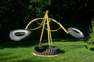 Mark di Suvero / 
Love Makes the World Go Round, 1962-63 / 
Steel and rubber tires / 
73 1/2 x 119 x 75 in (187 x 302 x 191 cm) / 
Private collection