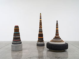 Tony Cragg / 
Peggs, 1988 / 
concrete, graphite, plastic, metal, stone, rubber, wood, glass / 
Part A: 60 x 40 x 40 in. (152.4 x 101.6 x 101.6 cm) / 
Part B: 80 1/2 x 22 x 22 in. (204.5 x 55.9 x 55.9 cm) / 
Part C: 50 x 19 3/4 x 19 3/4 in. (127 x 50.2 x 50.2 cm)