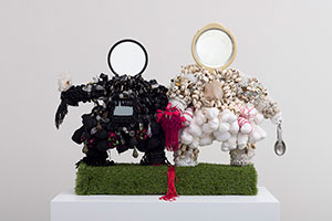 Vanessa German / 
This Togetherness, (Couples Therapy), 2021 / 
love, wood, astroturf, 1 vintage mirror, 1 new mirror, bone beads, sorrow, keys, forgiveness, vision, terror, loneliness, selfishness, blood, hate, shame, rage, cannabis, saltwater, tears, salt, horror, beaded trim, locks and keys, prayer beads: yarn, cotton, textile, desperation, hiding, magic, medicine, healing, measuring spoons, clear quartz, black tourmaline, good sex, bad sex, masturbation, amethyst, brass mask beads, lies, vulnerability, binge eating, cowrie shells, self-loathing, buttons, compromise, eye- contact, slowness, softness, wire, glass beads, tears, agate, grace, mercy / 
25 x 33 x 12 in. (63.5 x 83.8 x 30.5 cm)