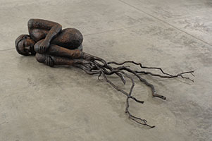 Alison Saar / 
Bareroot, 2007 / 
wood, bronze, ceiling tin and tar / 
17 x 81 x 48 inches (43.2 x 205.7 x 121.9 cm) / 
Private collection 