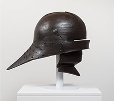 Ben Jackel / 
Sallet with Bevor, 2016 / 
toneware and beeswax / 
Helmet: 21 1/2 x 30 1/4 x 18 1/2 in. (54.6 x 76.8 x 47 cm) / 
Helmet on Stand: 26 1/2 x 30 1/4 x 18 1/2 in. (67.3 x 76.8 x 47 cm)
