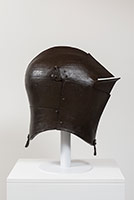 Ben Jackel / 
Great Bascinet, modified for joust, 2016 / 
stoneware and beeswax / 
Helmet: 23 1/4 x 25 1/2 x 14 3/4 in. (59.1 x 64.8 x 37.5 cm) / 
Helmet on Stand: 30 x 25 1/2 x 14 3/4 in. (76.2 x 64.8 x 37.5 cm)
