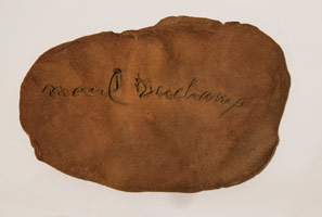 Marcel Duchamp / 
Marcel Duchamp (Signature), 1965 / Signature incised in clay (then fired) / 
11 x 7 1/2 x 1 in. (27.9 x 19.1 x 2.5 cm) Framed Dimensions: 13 1/2 x 16 x 3 in. (34.3 x 40.6 x 7.6 cm)